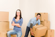 © CandyBox Images - Moving home young couple carrying cardboard boxes