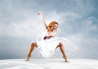 Jump of ballerina with dress of milk