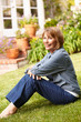 © Monkey Business - Senior woman relaxing in garden