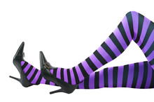 Sexy Witch's Legs In Striped Stockings And High Heels.