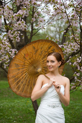 portrait of bride with a japanese umbrella under an oriental che