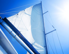 Sails Over Blue Sky. Yachting Concept. Sailboat