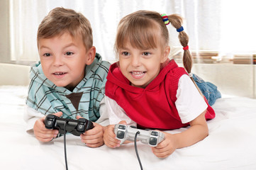 Happy girl and boy playing a video game