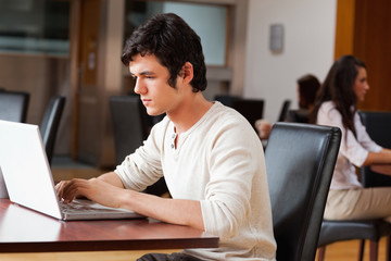 Handsome man using a notebook