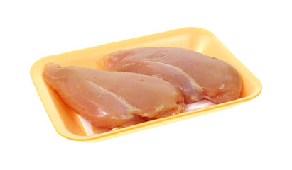 Fresh chicken breast in yellow tray