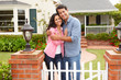 © Monkey Business - Hispanic couple outside home