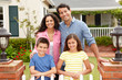 © Monkey Business - Hispanic family outside home