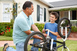 © Monkey Business - boy and grandfather fixing bike