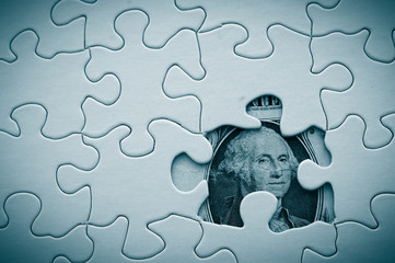 dollar bill and puzzle pieces