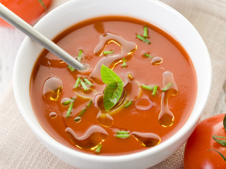 Wall Mural - tomato soup with basil leaf on bowl