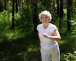 © Sergey Nivens - Elderly woman likes to run in the park