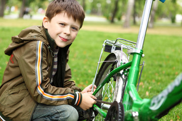 Boy on a bicycle in the green park