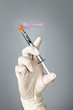 Syringe held by gloved hand