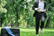 Business man running in park - training