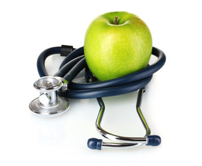 Medical stethoscope and apple isolated on white