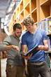 © WavebreakmediaMicro - Portrait of male students looking at a book