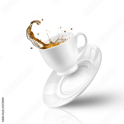 Fotografie, Obraz Splash of tea in the falling cup isolated on white