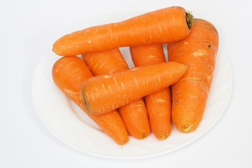 Ripe fresh carrots on a white background.