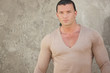 Image of a muscular man in a v-neck shirt