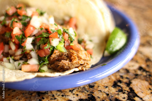 Fotografie, Obraz Delicious shredded beef taco at a restaurant.