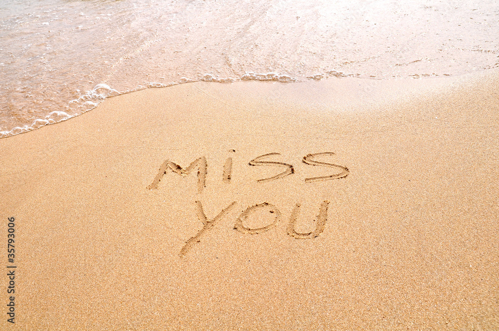 Miss you text written on the beach sand - obrazy, fototapety, plakaty 
