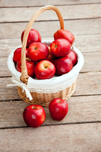 Basket Of Red Apples On Wood Floor