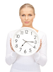 woman holding big clock