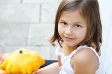 Little, Caucasian Girl Holding Pumpkin In Her Hands