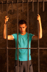 Wall Mural - Man with hands tied with rope behind the bars