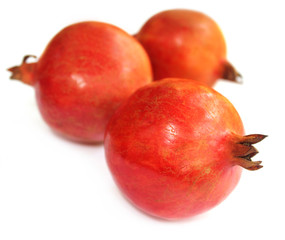 Canvas Print - Ripe pomegranate with oranges in selective focus