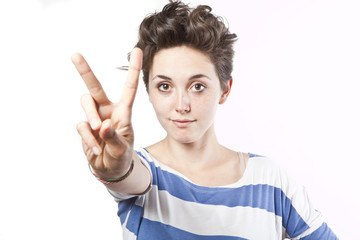 beautiful young girl making a victory sign isolated over white b