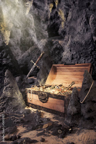 open treasure chest with bright gold in a cave