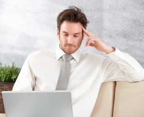 Poster - Young businessman working on laptop