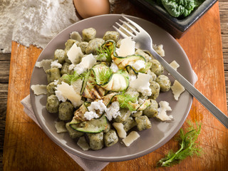 Wall Mural - spinach gnocchi with ricotta zucchinis and parmesan flakes