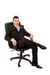 © cristovao31 - Relaxed young business man sits on office chair over white backg