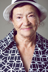 Wall Mural - Senior lady posing on gray background.