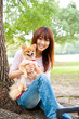 © taka - attractive asian woman with dog in the park