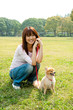 © taka - attractive asian woman with dog in the park