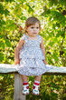© Shchipkova Elena - Little girl sitting on a bench in the garden