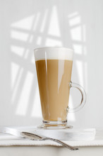 Coffee Latte With Frothy Milk In Tall Glass
