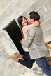 © goodluz - Cheerful couple in front of their house under construction