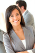 © goodluz - Portrait of beautiful businesswoman standing in front of group