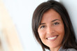 © goodluz - Beautiful saleswoman standing with group of business people