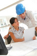 © goodluz - Architects working in office with electronic tablet