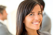 © goodluz - Portrait of beautiful businesswoman standing in front of group