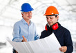 © Minerva Studio - Engineer and a worker in a construction site
