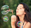 © Vladitto - Pretty woman inflating soap-bubbles
