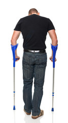 Wall Mural - Caucasian man with crutches back view isolated white background