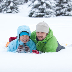 Wall Mural - Portrait of the hikers lying in snow