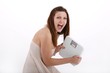 young woman with bathroom scale crying